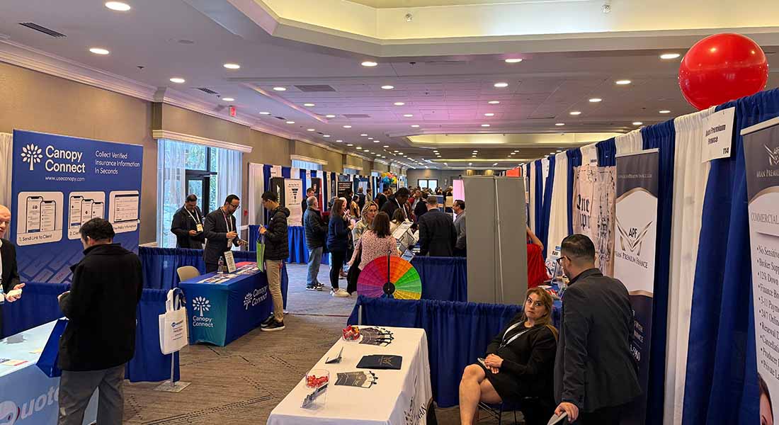 A lively trade show hall at Houston Mariott Westchase buzzing with Insurance Professional Netwroking With Each Other