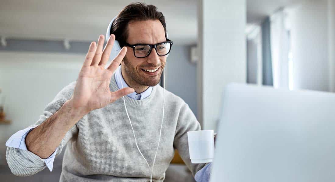 An insurance telemarketer warmly greeting clients online.