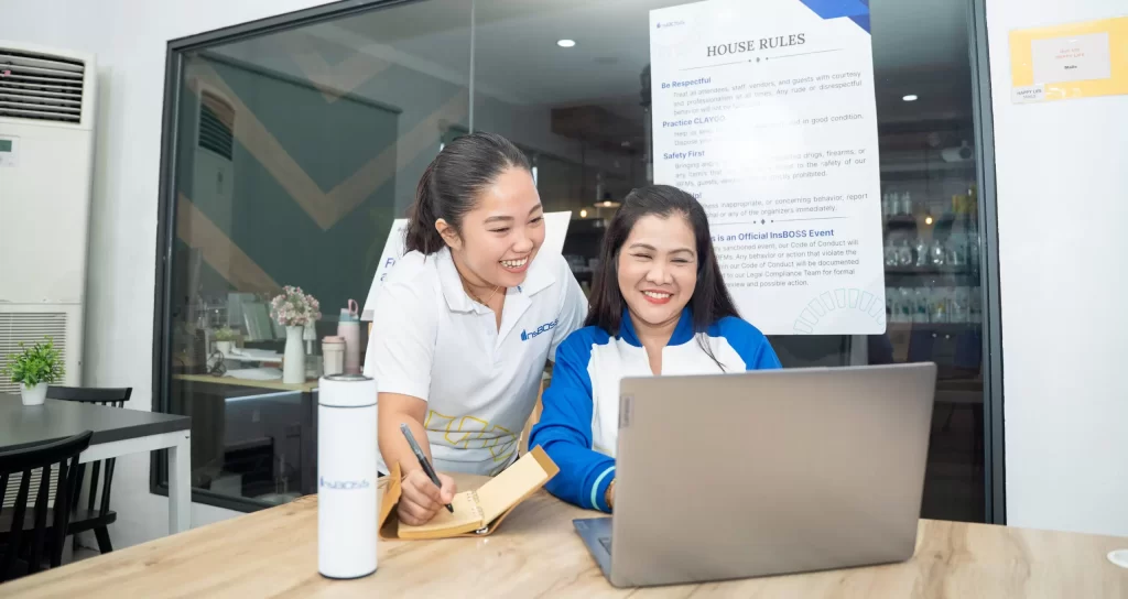 An **InsBOSS** trainer providing **onboarding guidance** and reviewing company rules with a new employee during a team training session.
