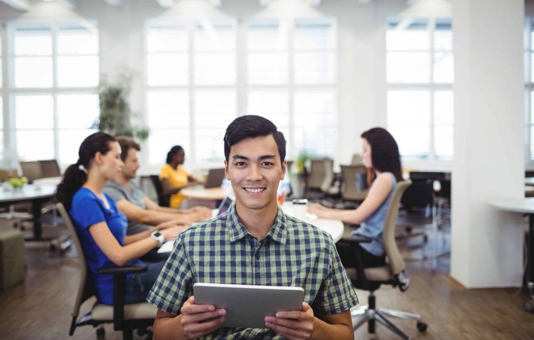 Portrait of man holding digital tablet in the office