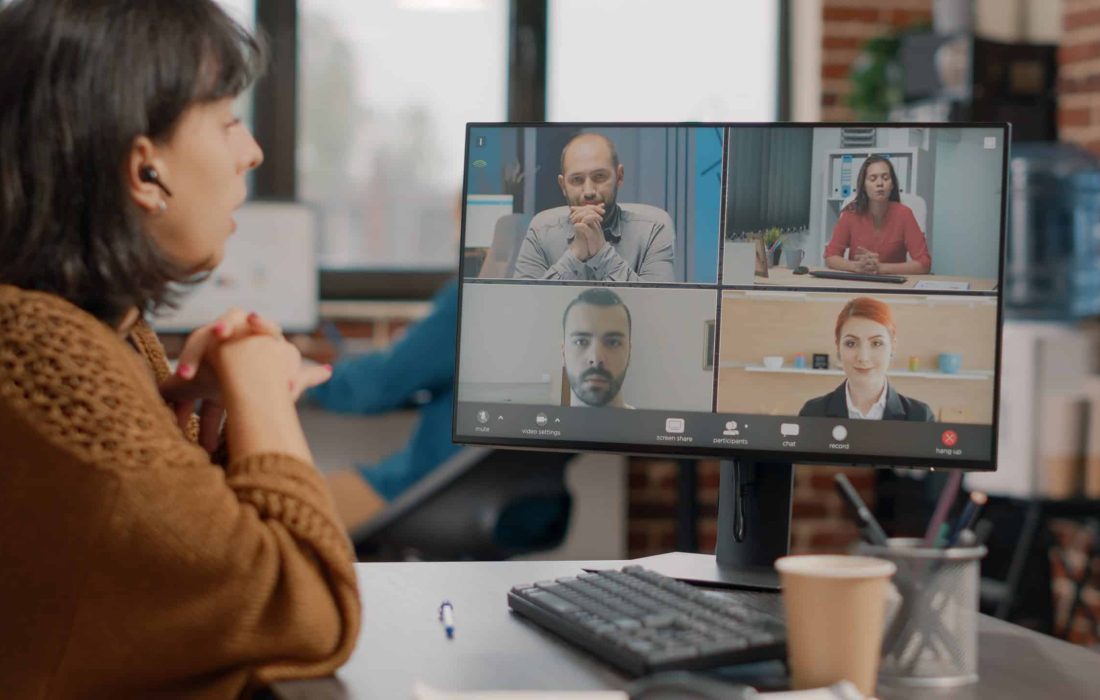 Woman attending business meeting on video call with workmates to discuss about project planning and strategy. Employee doing teamwork with colleagues on online video conference.